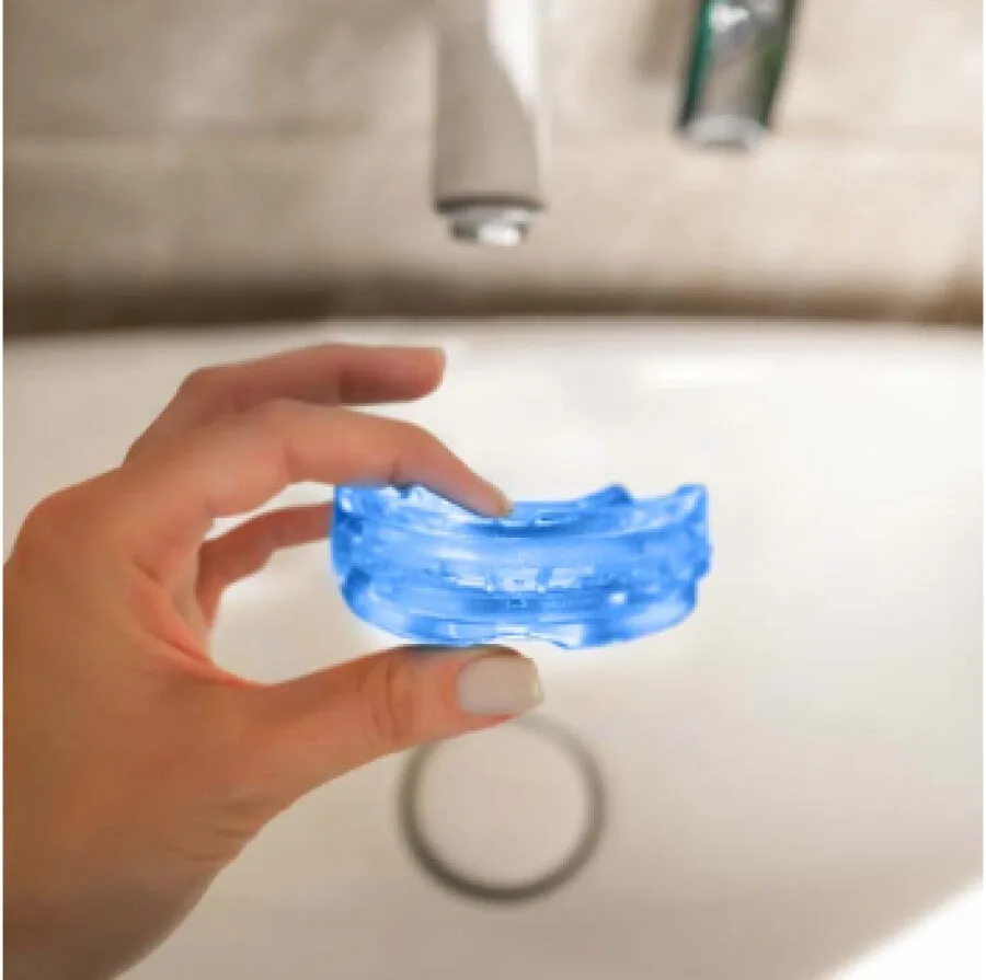 Rinsing the SleepZee mouthpiece under running water